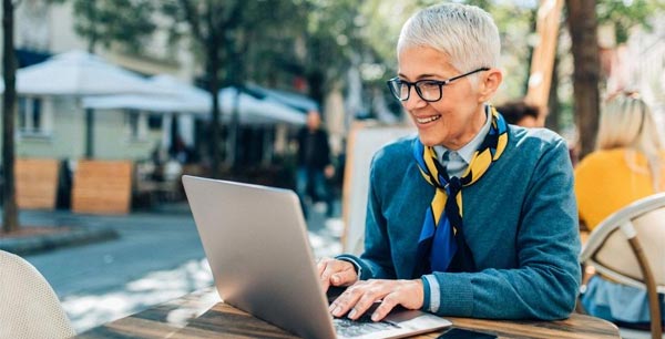 Photo of a lady with gray hair on a laptop