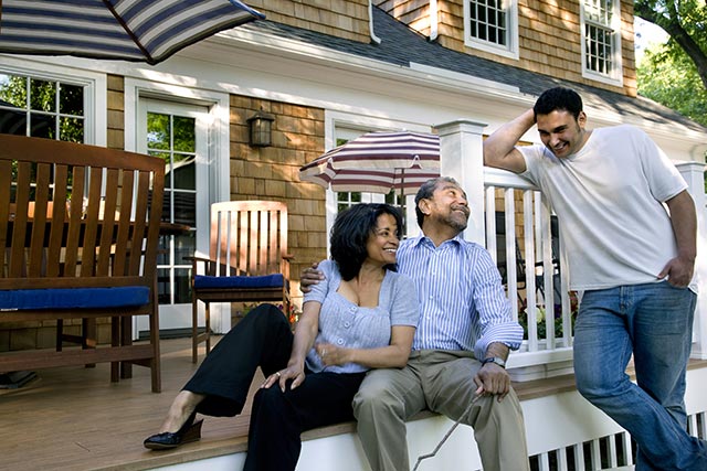 Image of a family chatting in a backyard