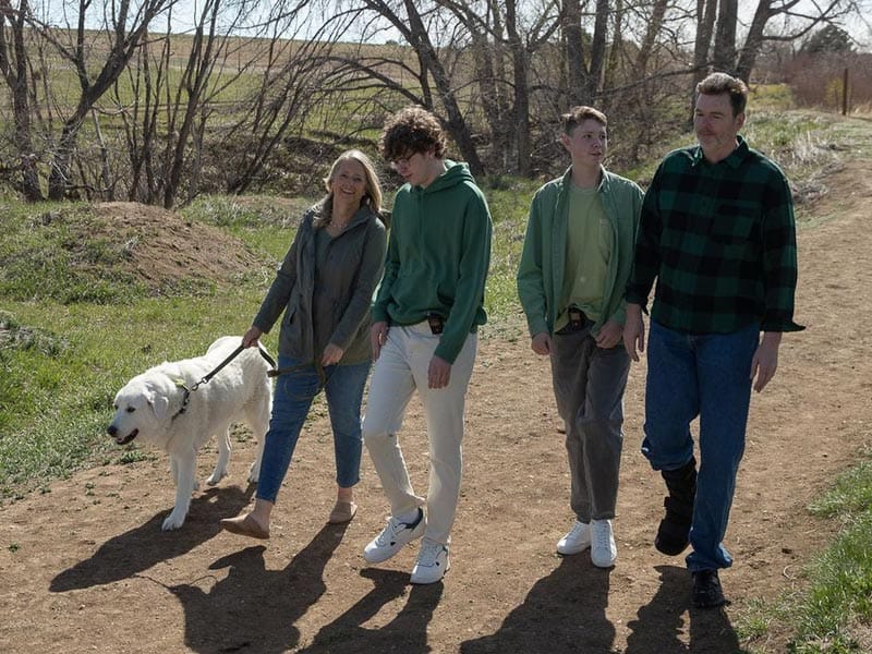 Family walking the trail with dog