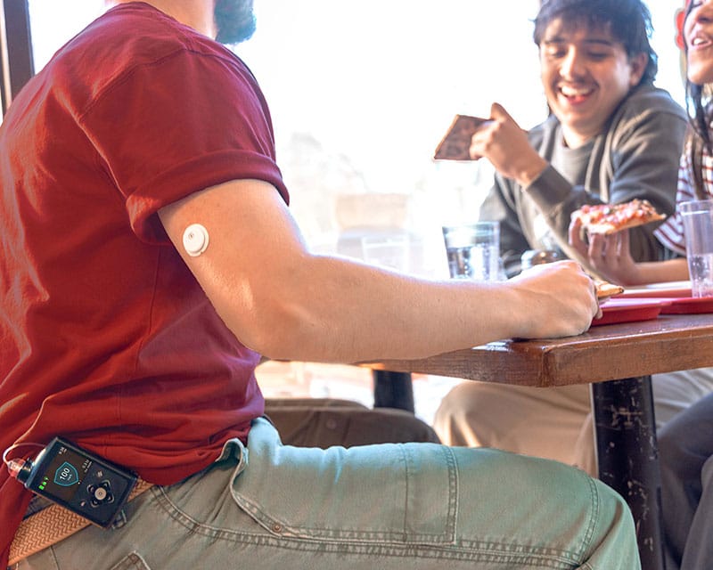 Main with MiniMed Instinct sensor on the arm