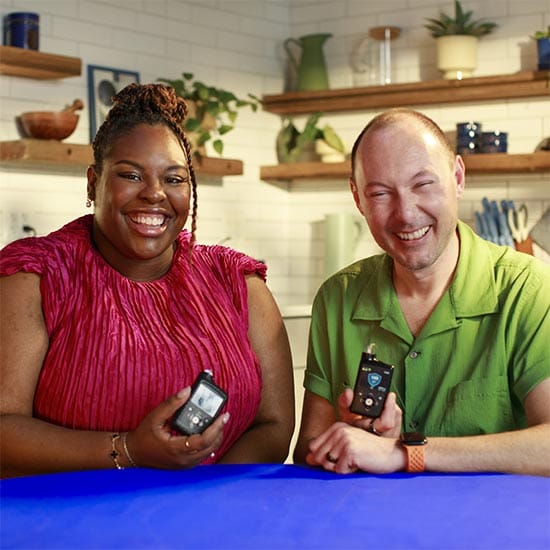 Man and woman holding medtronic insulin pump