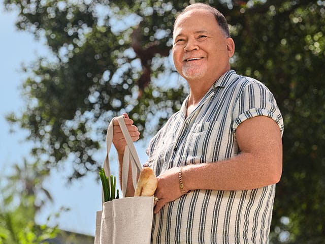 Main holding a grocery bag'